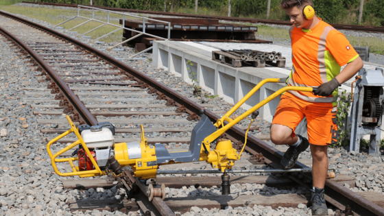 Auszubildender Gleisbau arbeiten mit Universal Schraubmaschine